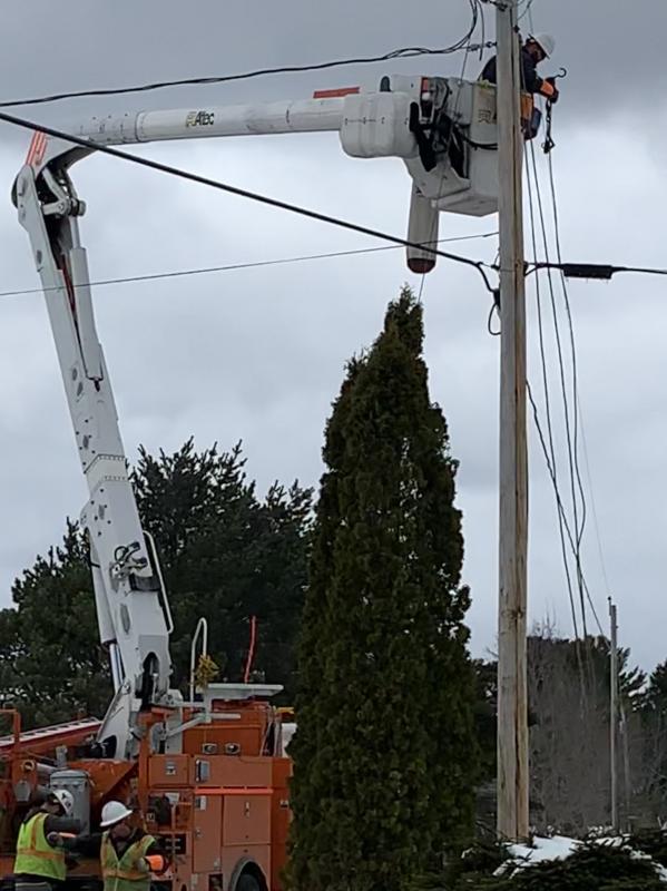 On the ground and high above, a Central Maine Power crew works Saturday on Route 218 near the Alna fire station, which served as a shelter in the outage. SUSAN JOHNS/Wiscasset Newspaper