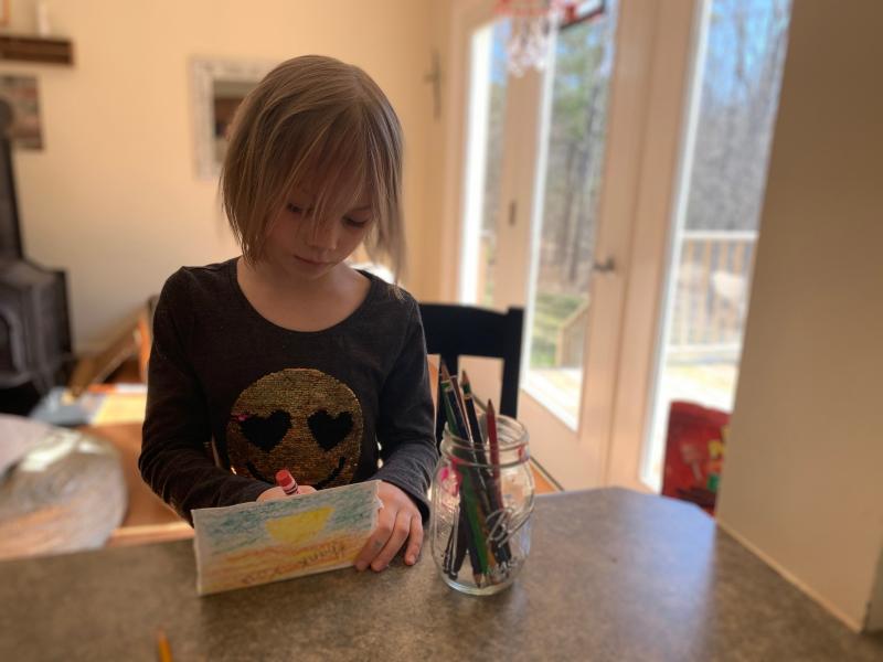 A student works on a card. Courtesy of Damariscotta Montessori