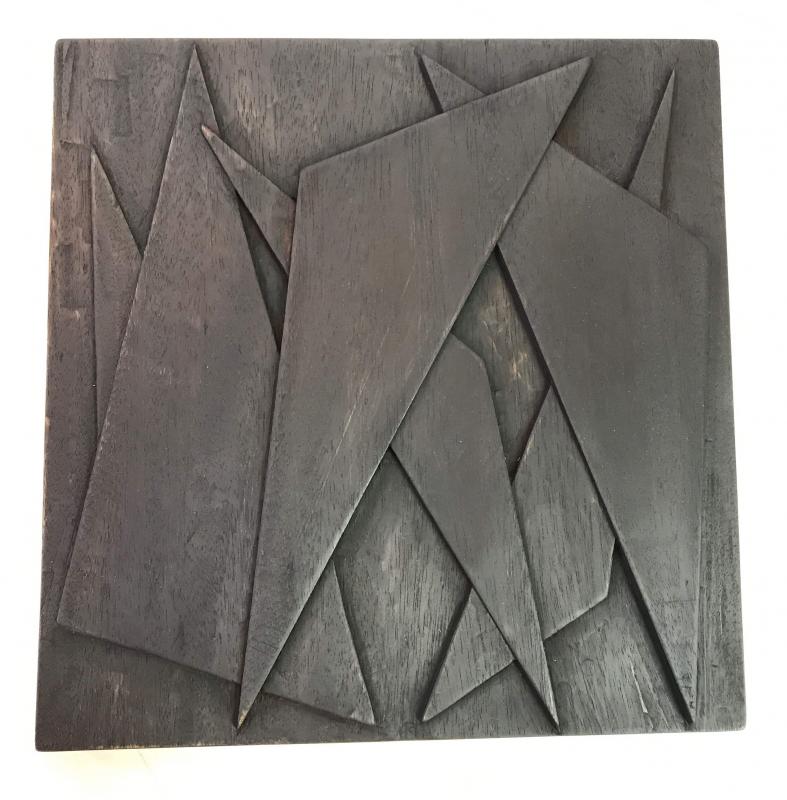 “Shards” - one in a series of seven mahogany, carved relief wall sculptures, 11” x 11” x 1” in the sunlight, by Eben Blaney. Eben Blaney.