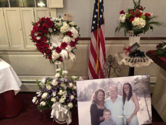 The portrait of hospice worker Christii Maquillan, her husband, Robert, her daughter, Sam, and grandson, Brandon was placed by Robert’s casket during his funeral held in December before COVID restrictions banned large gatherings. Contributed photo