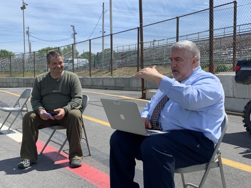 Teacher Chris Hammond, left, and WMHS Principal Charles Lomonte prep at Wiscasset Speedway June 10 for graduation
there. SUSAN JOHNS/Wiscasset Newspaper