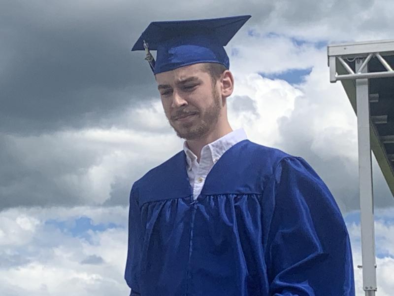 A graduate heads back to a car after his turn onstage getting his diploma. SUSAN JOHNS/Wiscasset Newspaper
