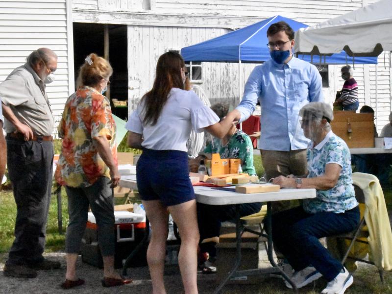 Town Clerk Anthony Blasi hands a ballot to a voter. PHIL DI VECE/Wiscasset Newspaper