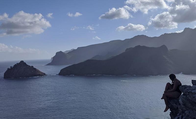Solo sailor Holly Martin enjoys the view overlooking the rugged coastline of Nuku Hiva island in the Marquesas. Courtesy of Holly Martin