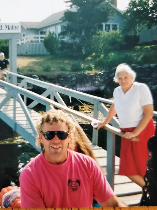 Bennie Alice Moore, on the gangway, and son Bob, on the dock, wait to greet the next group of visitors and lobster bake lovers at Cabbage Island. Courtesy of Ginny Moore Murray