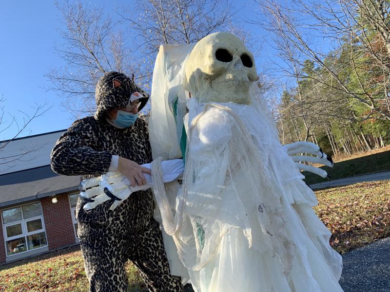 Wiscasset’s Dot Lamson adjusts a ghoul’s arms. SUSAN JOHNS/Wiscasset Newspaper fftfftTt