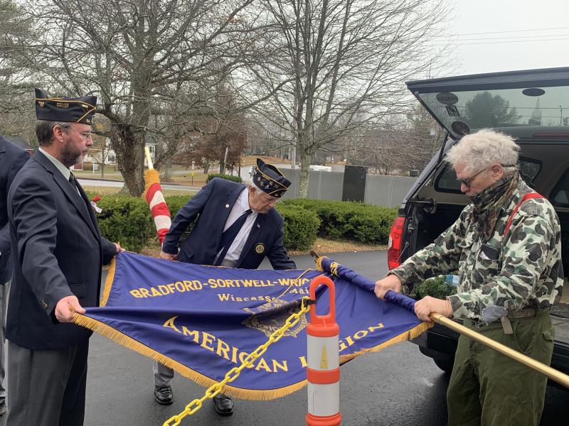 From left, American Legion Post 54’s Neil Page, Wally Pitcher and James Quinnam tend the flags post-ceremony. SUSAN JOHNS/Wiscasset Newspaper