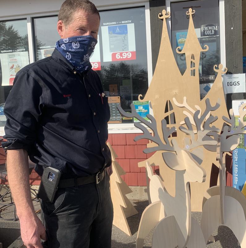 Ames True Value Supply co-owner Wayne Averill stands next to holiday-themed items Sumner Averill made. SUSAN JOHNS/Wiscasset Newspaper