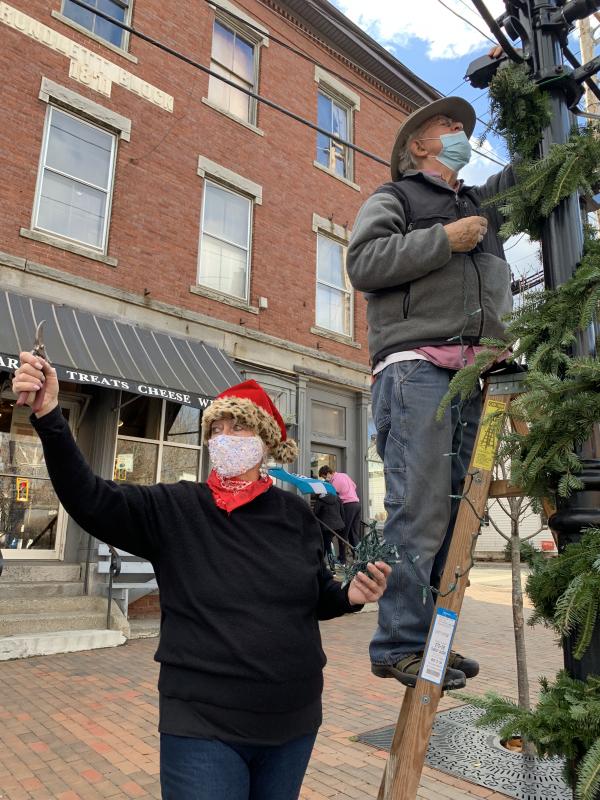 Terry Heller answers an off-camera call for clippers Nov. 14 as Larry Flowers does higher level work in the decorating of Wiscasset’s downtown for the holidays. SUSAN JOHNS/Wiscasset Newspaper