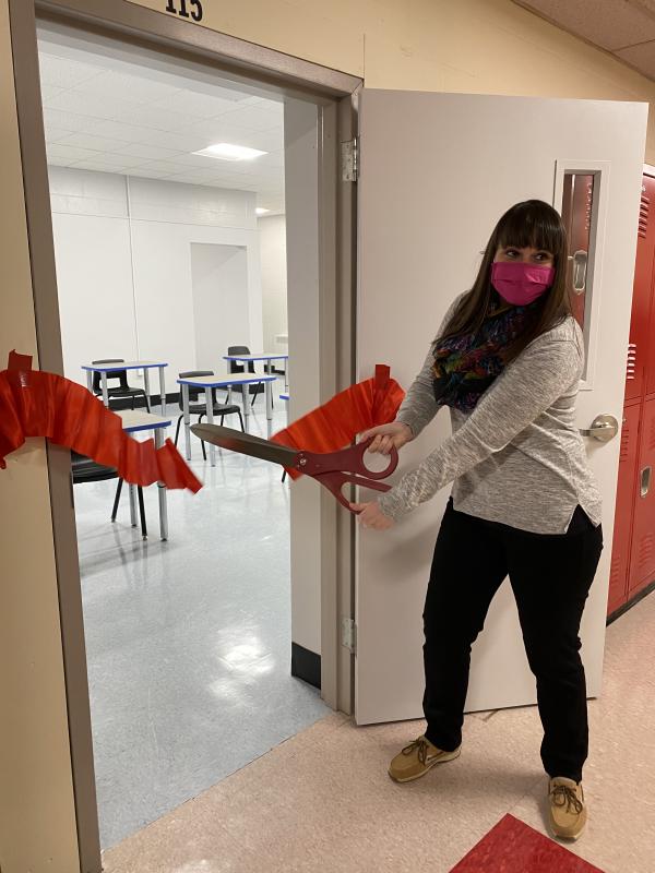 Liz Hemdal, who teaches health to all students grades 7-12, cuts the ribbon to her new classroom. Deb Pooler photo