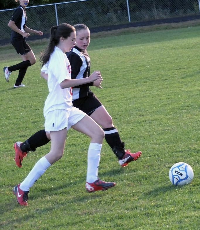 Wiscasset High School freshman Kennedy Orr beats a Lisbon player to the ball in fall 2012 soccer action. File photo