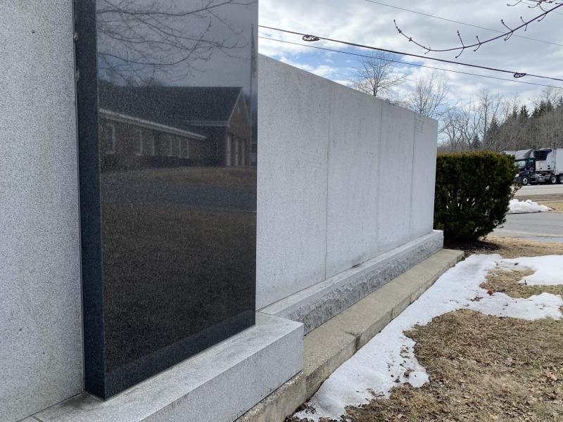 Snow recedes and the center of the veterans’ wall reflects Wiscasset’s municipal building March 9. SUSAN JOHNS/Wiscasset Newspaper