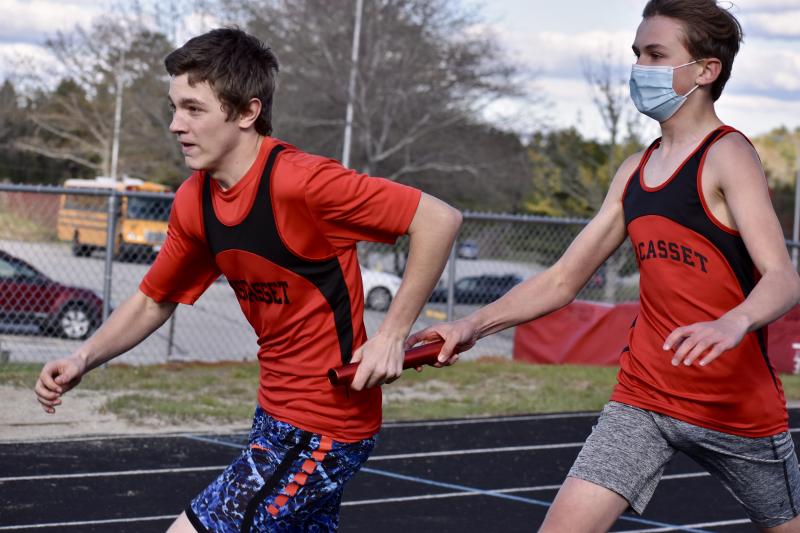 Austin Trask takes the baton from Payton Blagdon in the 4x100-meter relay race at Wiscasset Middle High School May 6. PHIL DI VECE/Wiscasset Newspaper