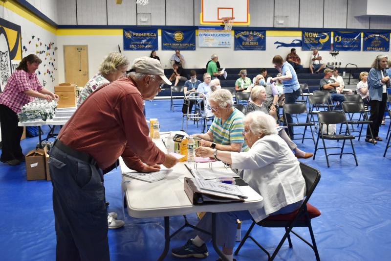 Ballot clerks check in voters at Woolwich’s annual town meeting May 26. PHIL DI VECE/Wiscasset Newspaper