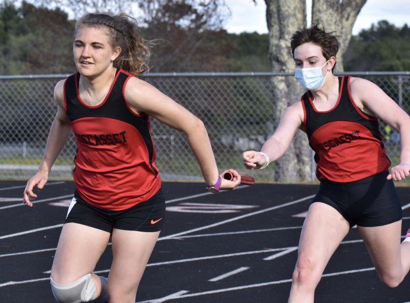 Josie Harrington takes the baton from Reese Hesseltine. PHIL DI VECE/Wiscasset Newspaper