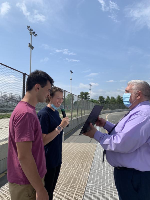 Principal Charles Lomonte holds the script for Matthew Eckert and Gwen Webber to read. SUSAN JOHNS/Wiscasset Newspaper