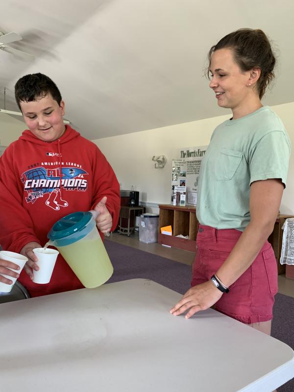 Larmanio Small pours some lemonade on a break at Morris Farm Monday as Morris Farm’s Liza Goss looks on. SUSAN JOHNS/Wiscasset Newspaper