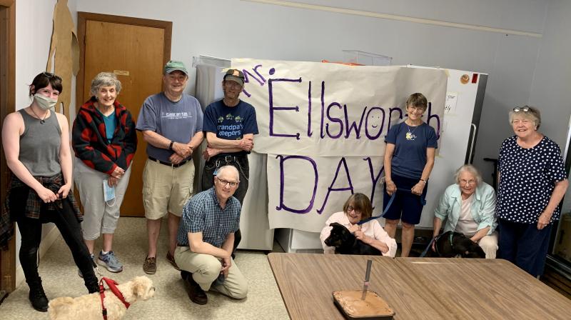 Standing, from left, inside St. Philip’s Episcopal Church June 14 are Help Yourself Shelf volunteer Kristen Haines with a neighbor’s dog, fellow volunteers Susan Ratigan and Deane Atwood, the guest of honor Ellsworth Stone and volunteers Sharman Ballantine and Joni Leigh. On the floor, from left, are volunteers Tom Junkert and Deborah Morgan, with volunteer Gretchen Burleigh-Johnson’s dog Bo, and Burleigh-Johnson with her dog Pippa. SUSAN JOHNS/Wiscasset Newspaper