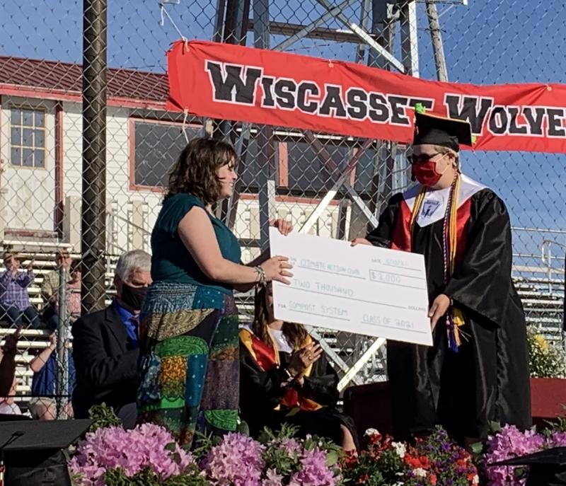 Ty DeLong, right, hands WMHS Climate Action Club’s Grace Greene the class’s $2,000 gift toward a composting system. SUSAN JOHNS/Wiscasset Newspaper