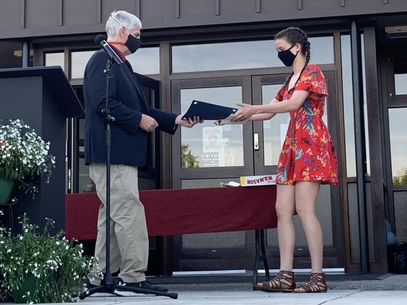 Athletic Director-Assistant Principal Warren Cossette hands an award to Eliza Paradis. SUSAN JOHNS/Wiscasset Newspaper