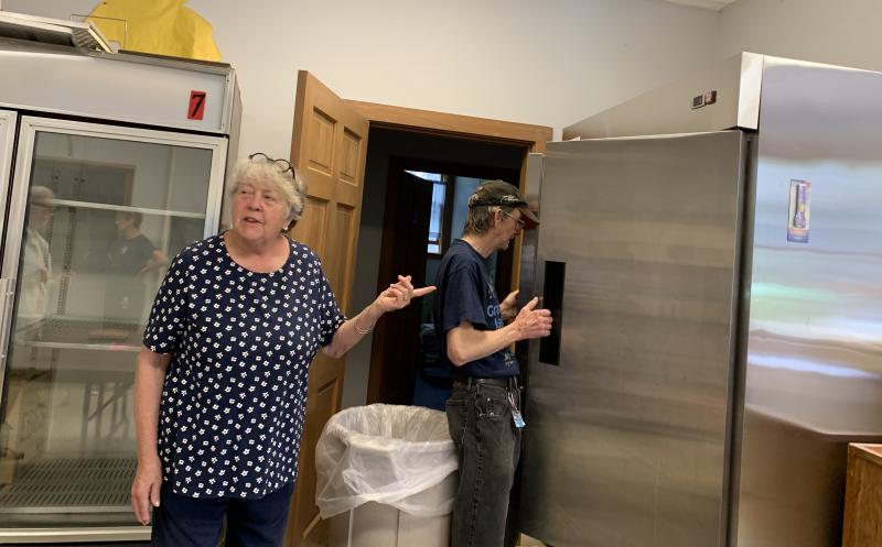 Joni Leigh stands by as Ellsworth Stone checks out the cooler the bottles he counted helped the pantry buy. SUSAN JOHNS/Wiscasset Newspaper