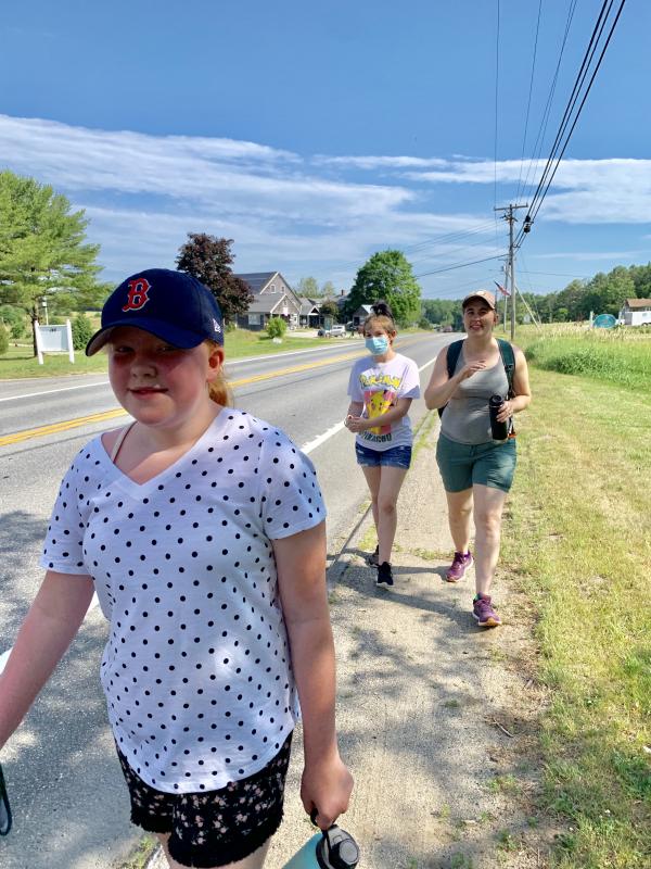 Delaney Withers and, behind her, Gabby Dotson and WMHS teacher Jessica Anderson, walk down Route 27 to head for Lincoln County Historical Association’s Old Jail Museum June 28. SUSAN JOHNS/Wiscasset Newspaper