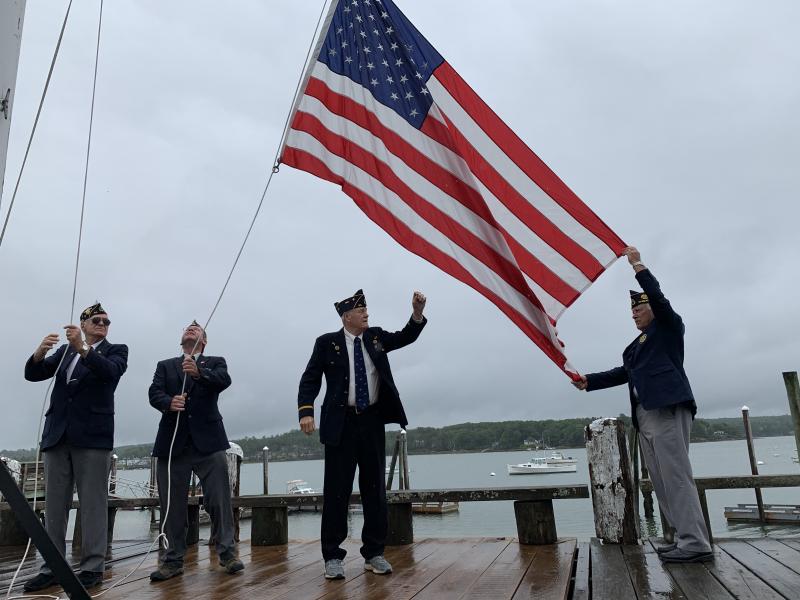 From left, American Legion Post 54 Commander William Cossette Jr. and members Neil Page, Bob Milligan and Wally Pitcher raise the American flag at the Wiscasset waterfront. SUSAN JOHNS/Wiscasset Newspaper