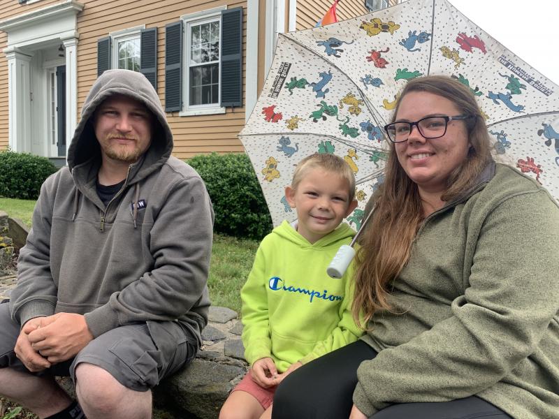 Matt Hansen and Samantha Davis and their son Luke Hansen, 5, await the parade on Federal Street. They usually watch from another point on the route but this year decided to sit down, Davis said. SUSAN JOHNS/Wiscasset Newspaper