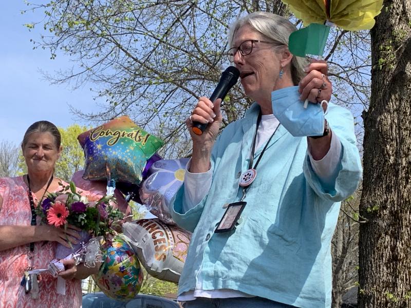 Reading interventionist Carol Adams holds some of the gifts for first grade teacher Trae Stover as Lincoln County’s teacher of the year addresses the school. SUSAN JOHNS/Wiscasset Newspaper