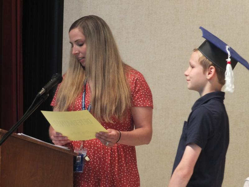 Sixth grade teacher Nicole Ellis presents Riley Mullins with a certificate recognizing his best personal trait, determination. BILL PEARSON/Boothbay Register