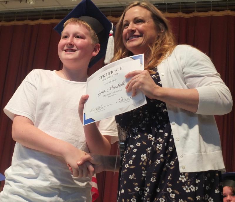 Jax Marshall receives his sixth grade diploma June 16 from Principal Dr. Christina Boursaw. BILL PEARSON/Boothbay Register