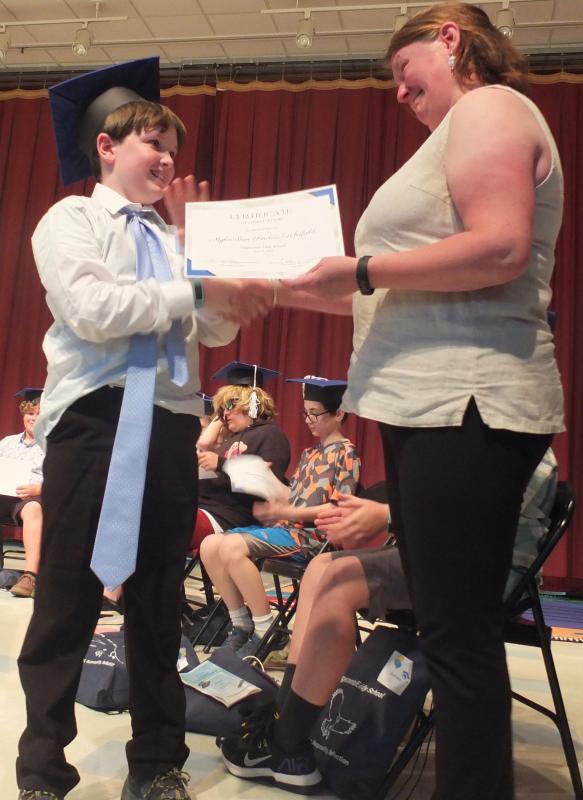 Edgecomb School Committee’s Heather Sinclair claims her son had a regular size tie when he left for school on June 16, but she is all smiles as she awards Myles Ian Sinclair-Whitfield his sixth grade diploma. BILL PEARSON/Boothbay Register
