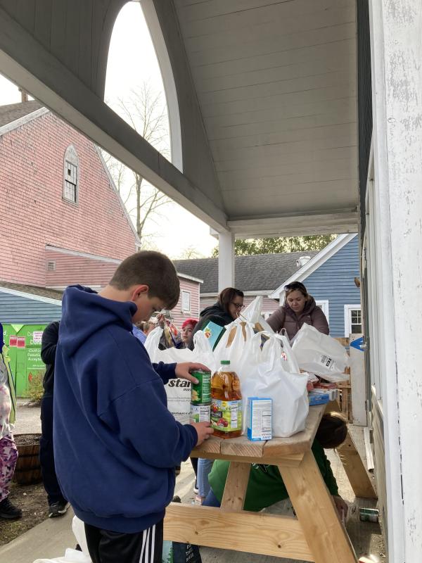 Fifth grader James Kenney helps organize donated items. EDNA MILLER/Wiscasset Newspaper