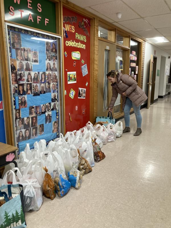 Partners in Education Chair Wendy Tarrance organizes bags of food in the school lobby. EDNA MILLER/Wiscasset Newspaper