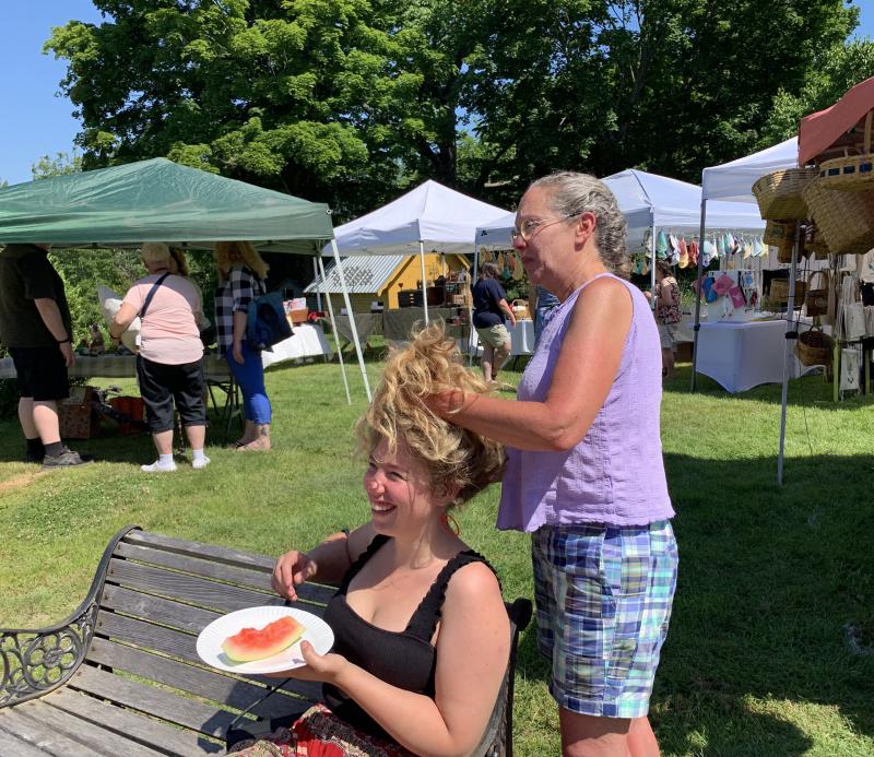 On a hot June 25 in Wiscasset, Laura Surrick and daughter Rebbeca Fox enjoy St. Philip’s Church’s first Strawberry Festival since the pandemic started. SUSAN JOHNS/Wiscasset Newspaper