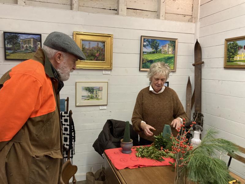 Mare LeMay explains the process of building a tree to Michael Olszewski of Wiscasset. EDNA MILLER/Wiscasset Newspaper