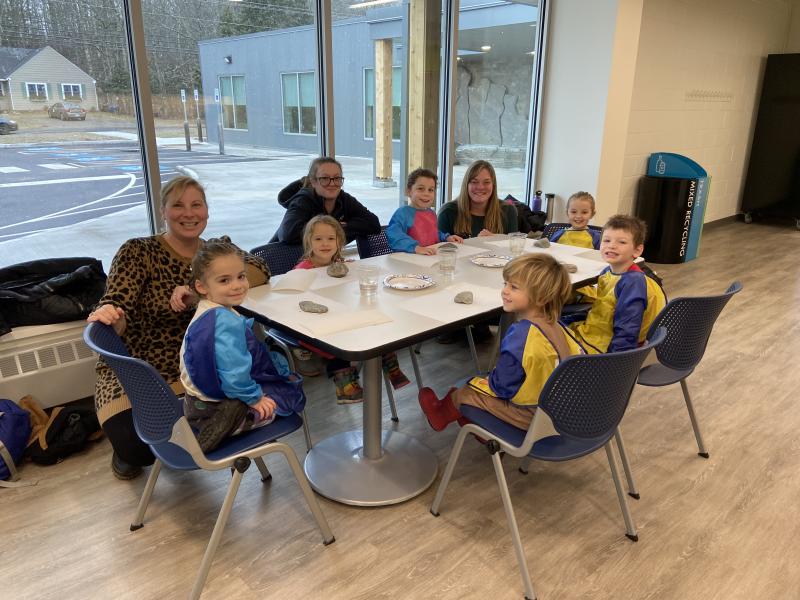 Hannah Wayda, the Child Enrichment Center Director, and some of the students from the Harbor Montessori School paint rocks at the Y. Courtesy of Allyson Goodwin