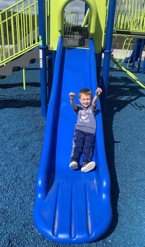Enjoying one of the new slides at Clifford Playground in Boothbay. File photo