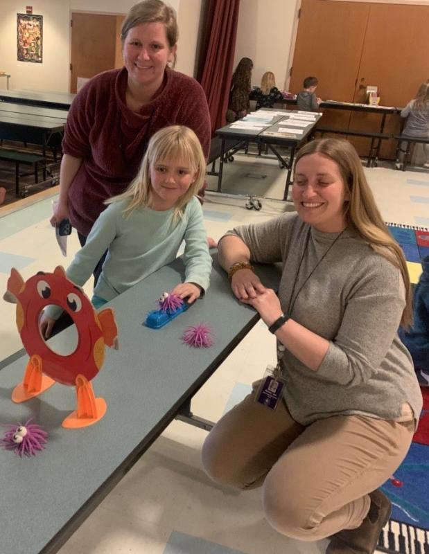 Edgecomb Eddy School Afterschool coordinator Brooke Chaney,left, and kindergarten teacher Sally Monroe enjoy a game of “Go, Fish, Launch” with second grader Mae. BILL PEARSON/Boothbay Register