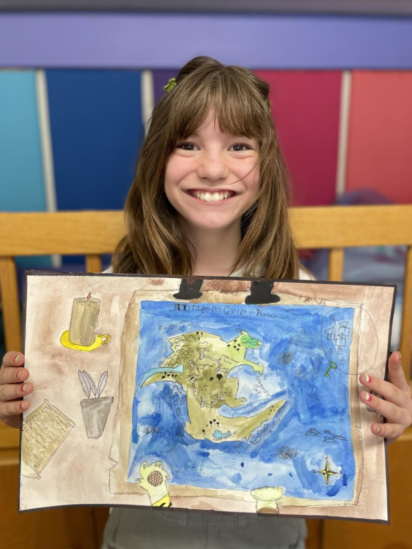 Lucie Hollan holds "A Dragon's Map of Pantala," which was selected as a Top Twelve finalist in Osher Map Library's annual Mapmaking Contest. Courtesy photo