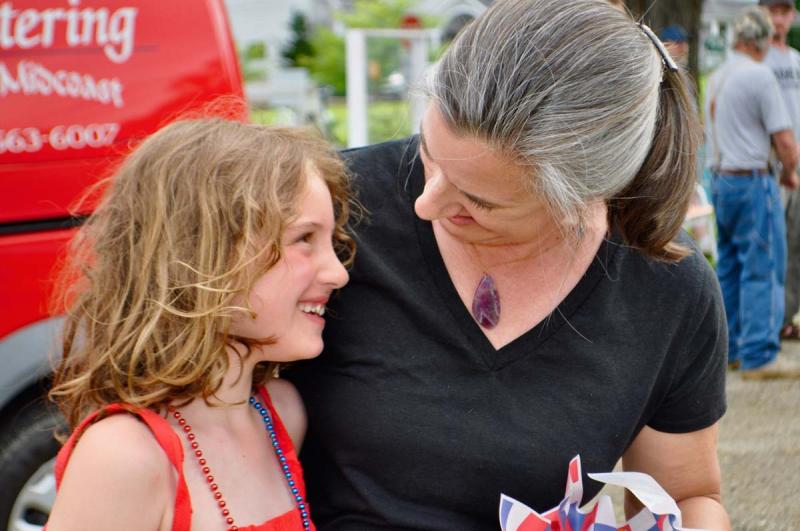 Stephanie McSherry of the Merry Barn visiting with a summer camper, Piper, at the fireworks party. July 4 The Lincoln Home Newcastle Maine