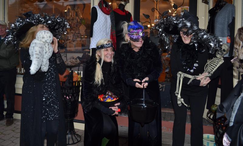 Adele and Andy of Slick’s, and company, watch as the trick or treaters approach during a Halloween Walk past. File photo