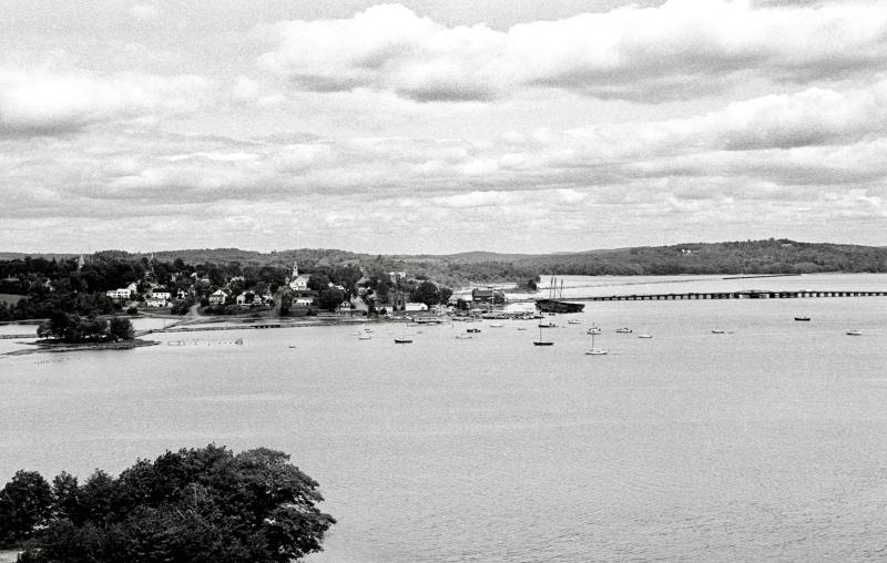 View of Wiscasset harbor taken from the Mason Station roof on the same morning of the oil tanker’s visit in July 1980. On the right is the former timber-pile Wiscasset bridge linking Wiscasset to Edgecomb showing its swing span. The former schooners Luther Little and Hesper can be seen, too. To the right is White’s Island and Bradbury Cove. PHIL DI VECE photo