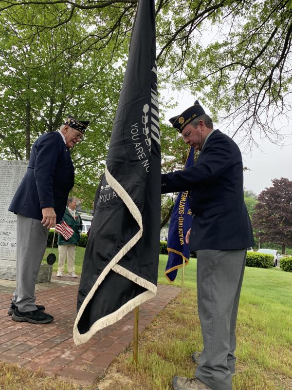 Post 54 Cmdr. William Cossette Jr., left, and Neil Page, service officer, set up the POW flag. SUSAN JOHNS/Wiscasset Newspaper