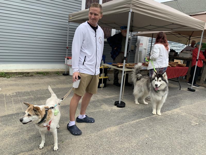 Pittsburgh’s Justin Gavazzi takes in the Strawberry Festival with his and wife Emily Babyak’s shiba inu Jennie, left, and husky Theo. The couple had been staying in the area en route to Bar Harbor. SUSAN JOHNS/Wiscasset Newspaper