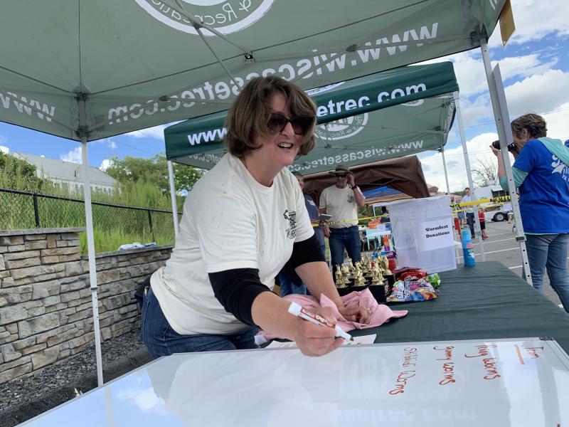 Wormfest co-organizer Tracey Whitney conducts the relay race June 8. SUSAN JOHNS/Wiscasset Newspaper