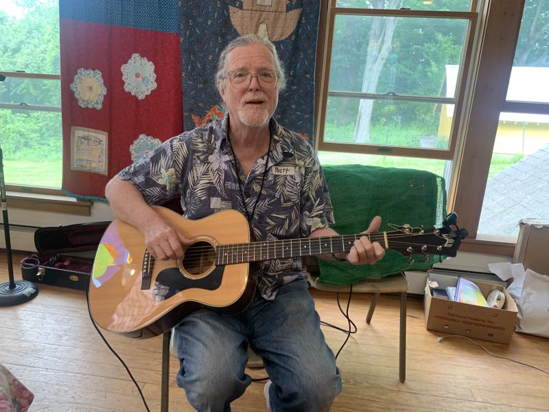 Mat O’Donnell plays while others eat at the Strawberry Festival. SUSAN JOHNS/Wiscasset Newspaper