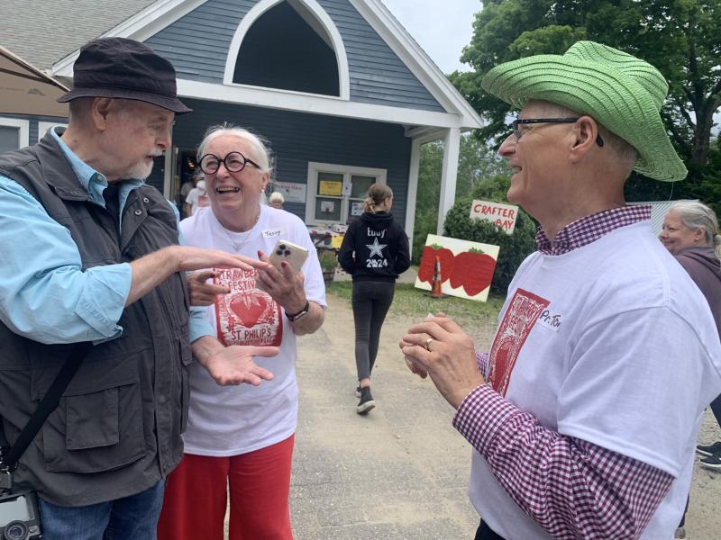 From left, photographer Bob Bond of 40 Federal Studio in Wiscasset, selectman and St. Philip’s member Terry Heller and outgoing St. Philip’s priest in charge Tom Junkert chat at the Strawberry Festival. SUSAN JOHNS/Wiscasset Newspaper