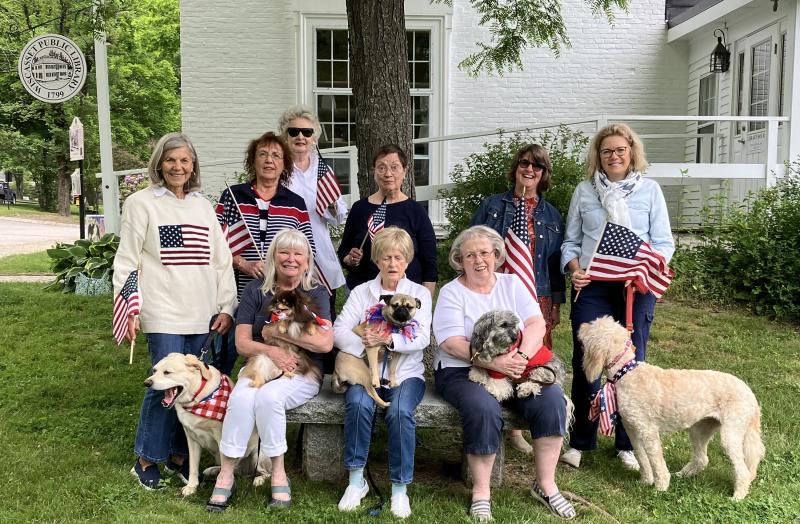 The Fundraising Committee of the Friends of the Wiscasset Public Library meets to plan Bands for Books. First row, from left, Linda Adams (with Oliver), Linda Winterberg (with Liberty), and Lynn Maloney (with Bradley). Second row, from left, Hannah Stewart (with Cooper), Barbara Britton, Kate Curran, Blanche Johnson, Tracey Whitney and Michelle Wentworth (with Sandy). Bill Maloney photo
