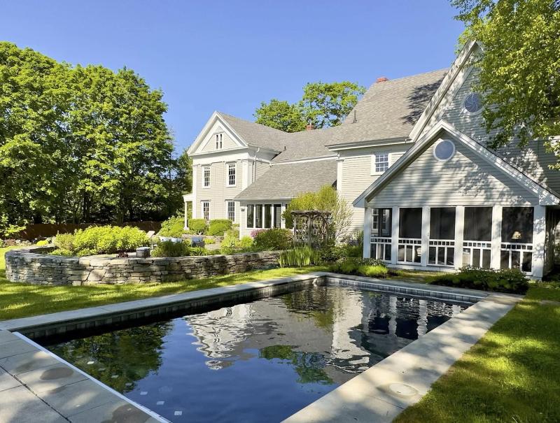 This Wiscasset estate, originally a modest home, now features pool, patio, and sweeping riverfront views. Courtesy of Wiscasset Creative Alliance